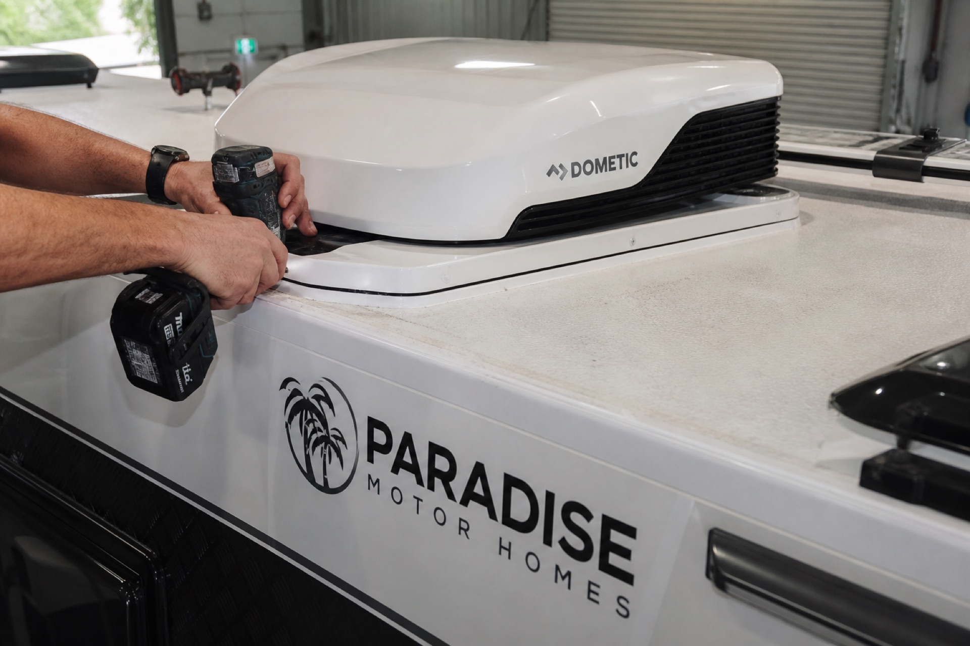 Technician finishing caravan air conditioner installation