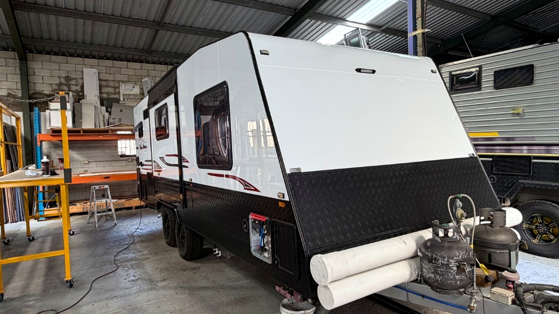 Finished caravan front view in workshop after exterior rebuild