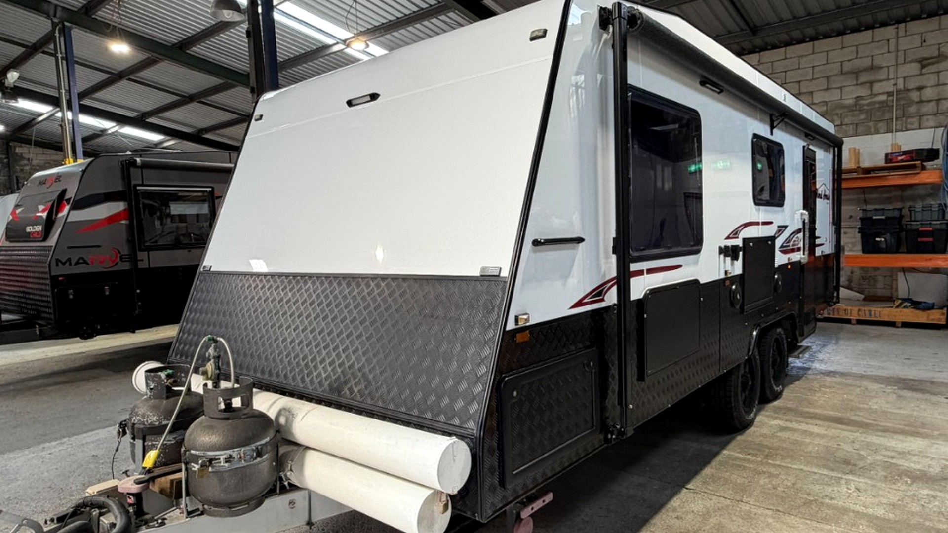 Finished caravan front-right view in workshop after exterior rebuild