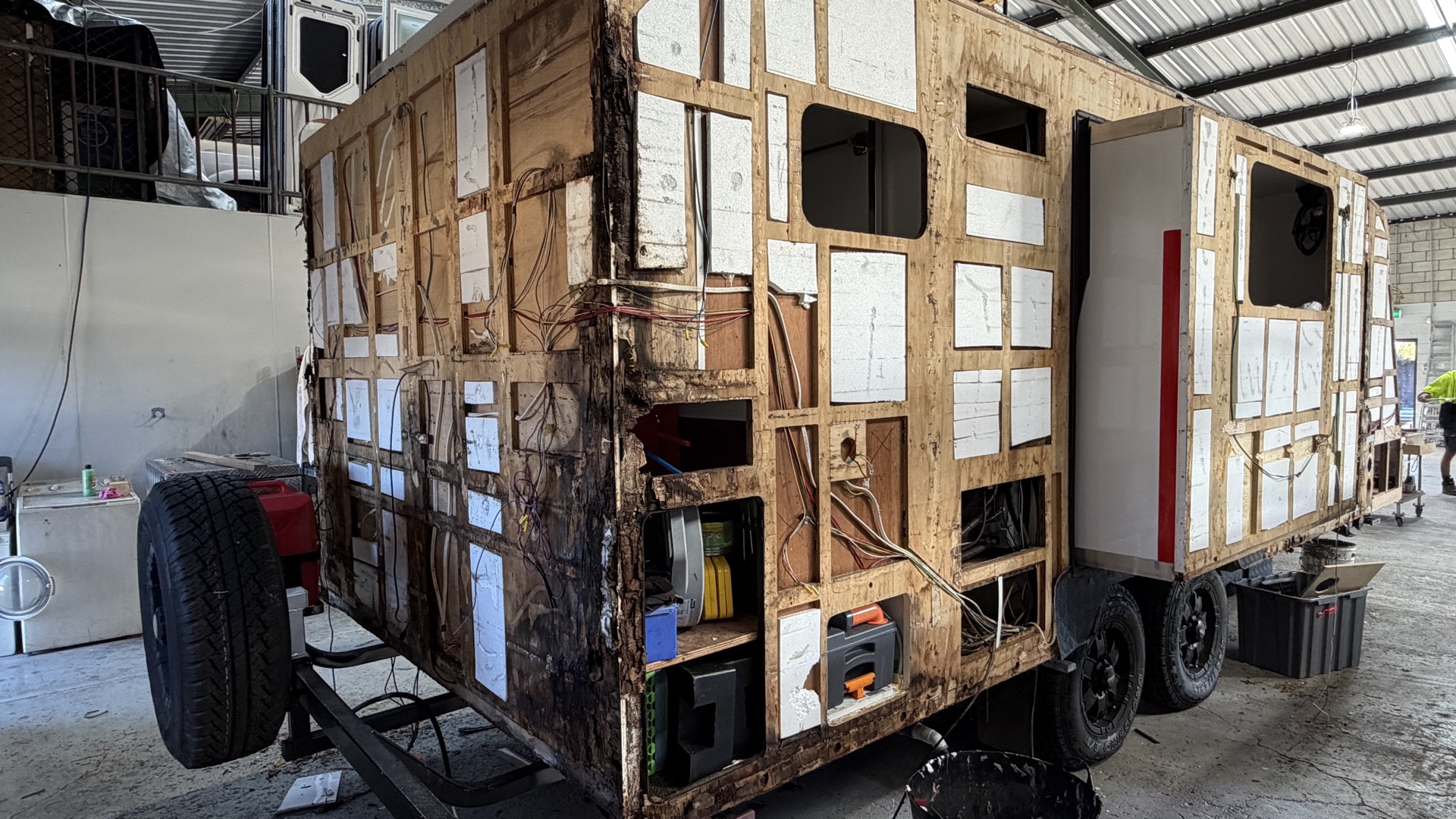 Caravan rear stripped with water-damaged framing exposed