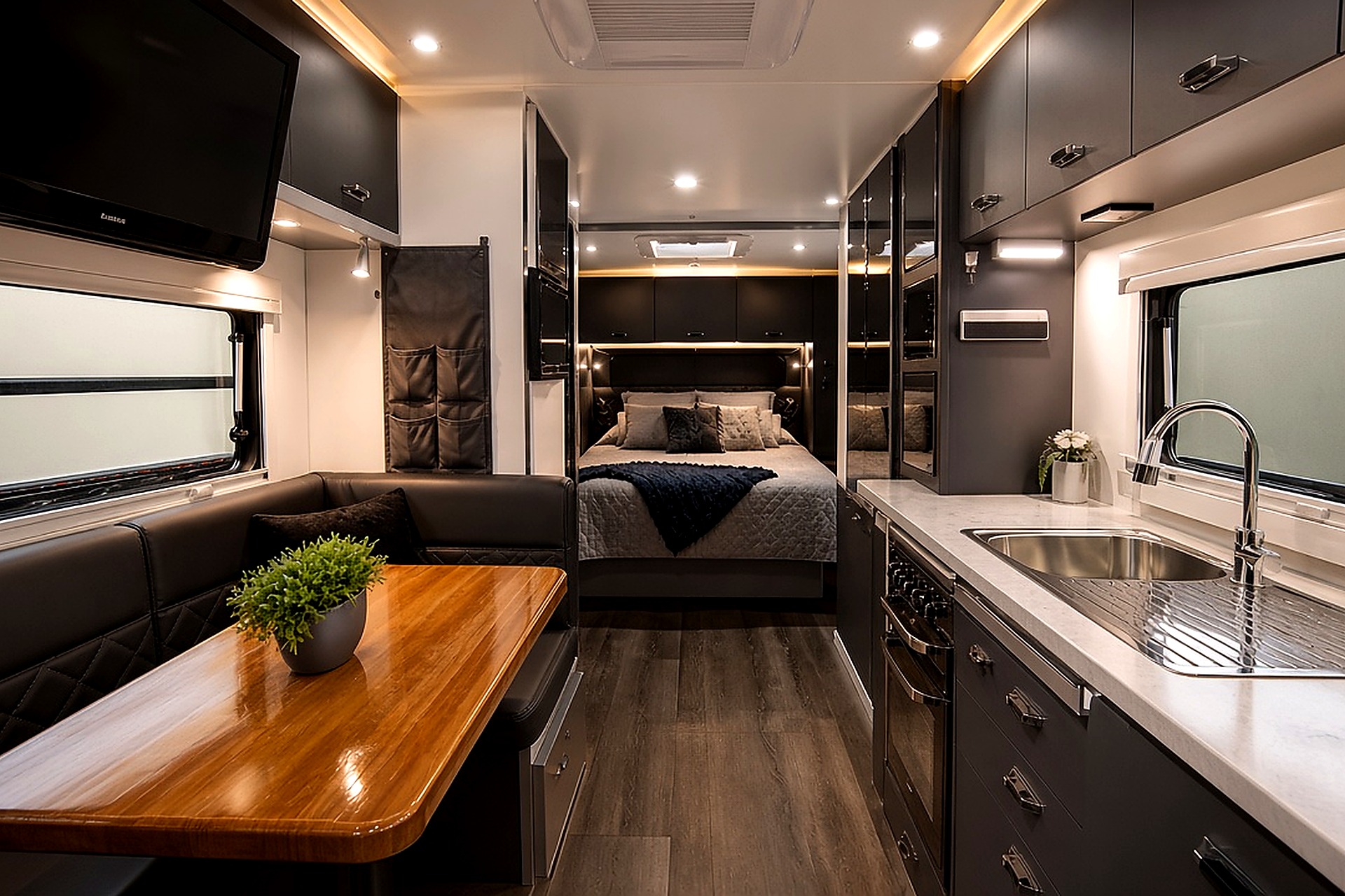 Modern luxury caravan interior fitout with kitchen lounge and bedroom