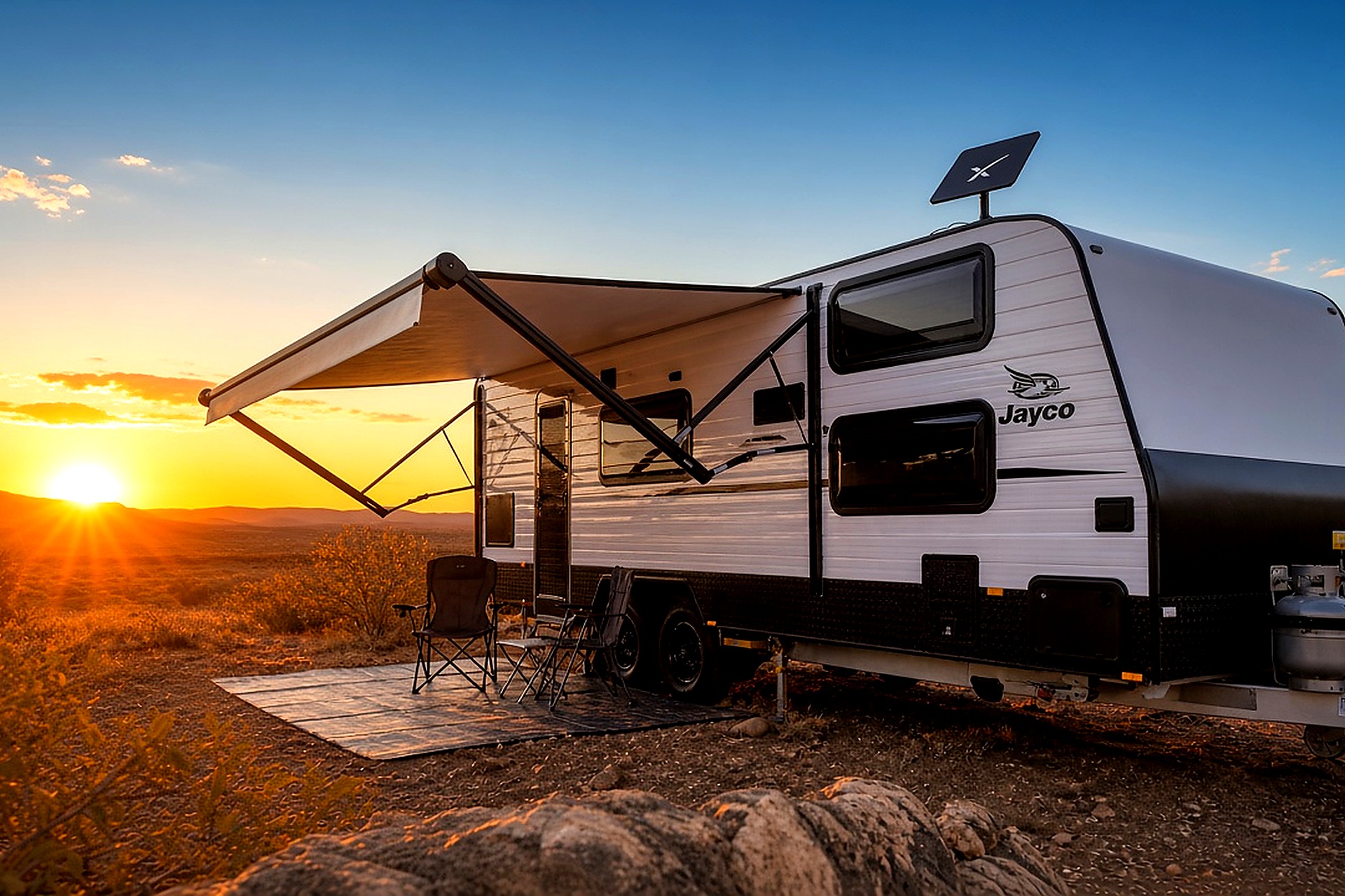 Caravan with Starlink dish installed at sunset campsite