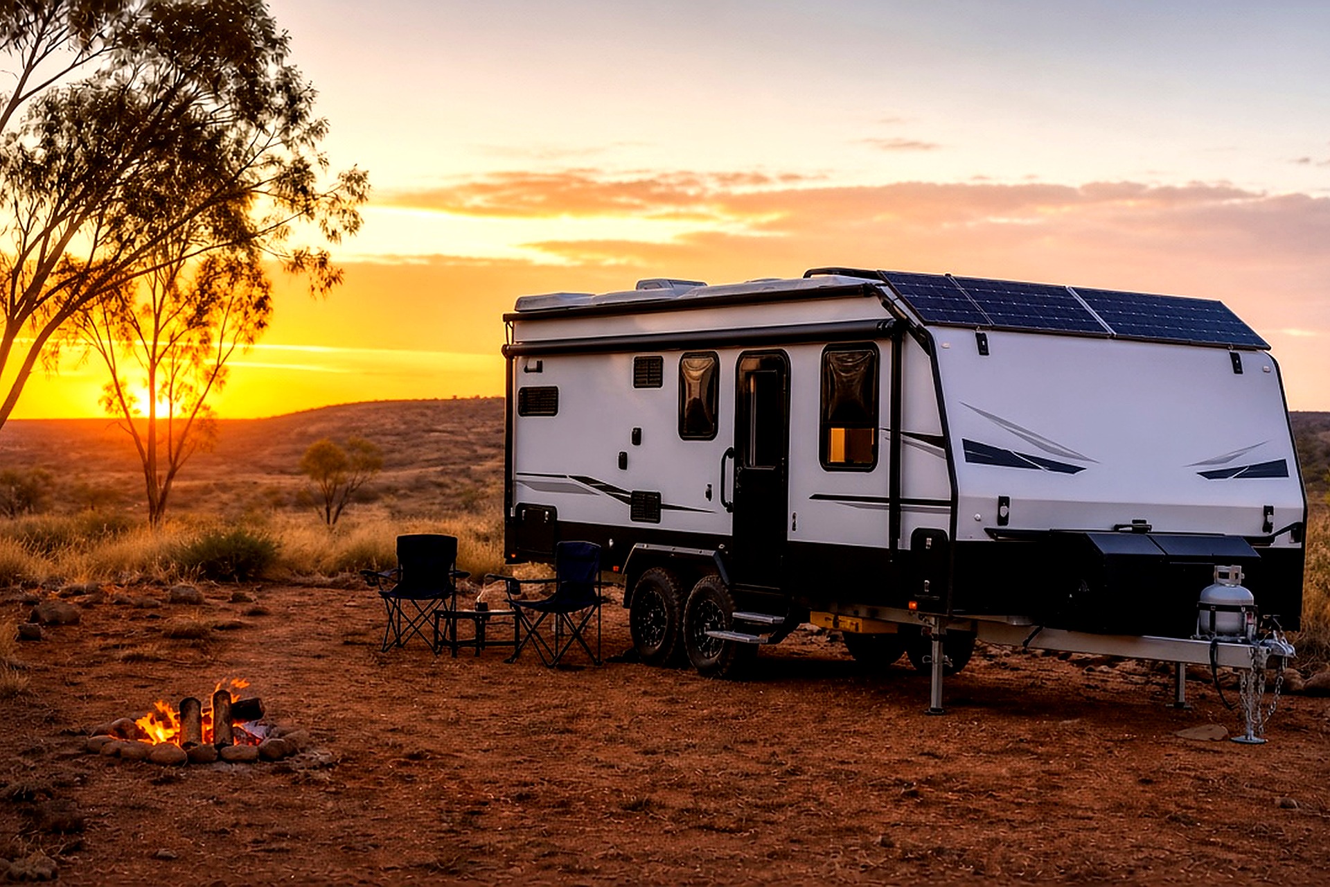 Caravan with solar panels installed at sunset campsite